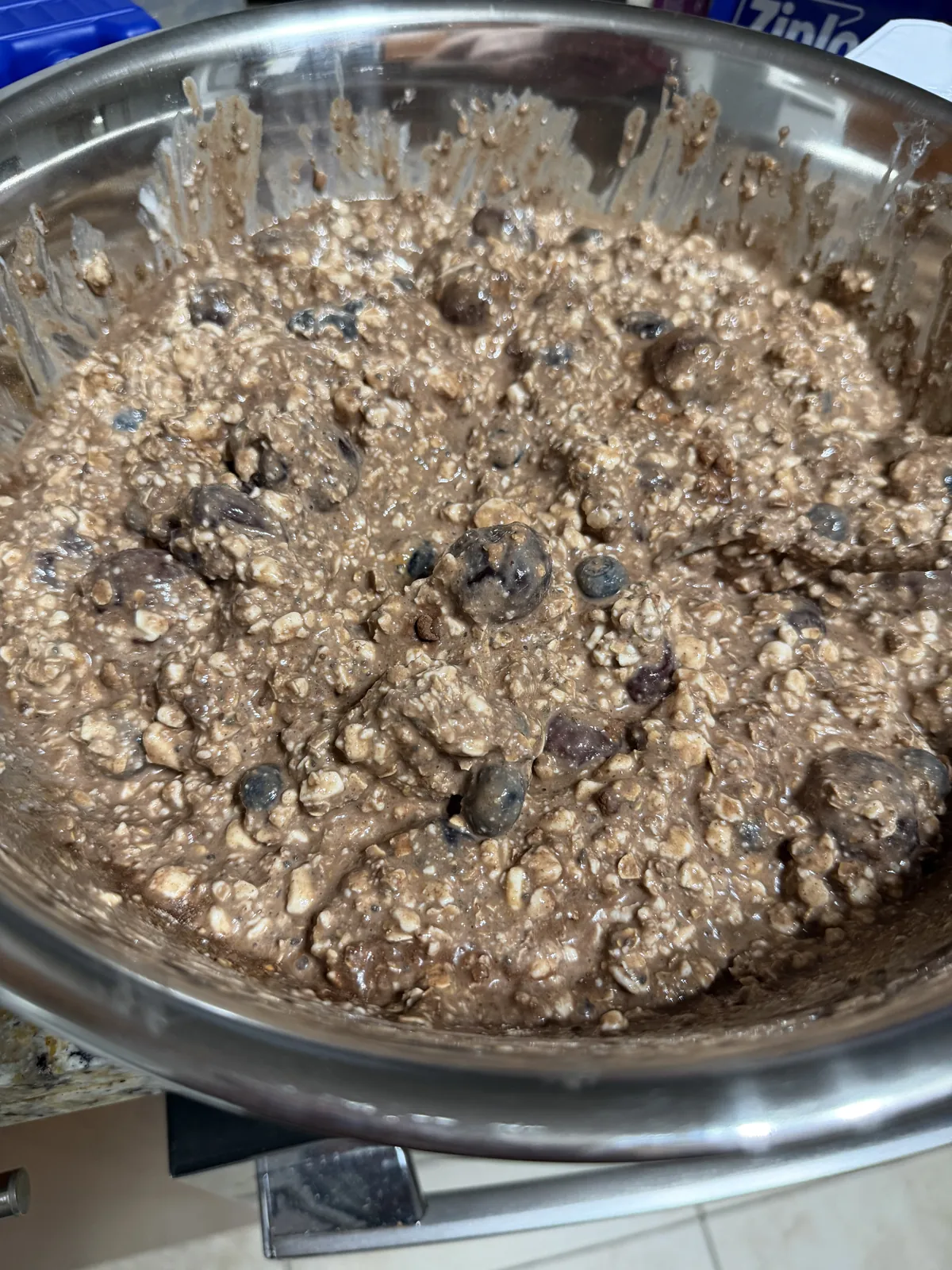 The mixed chocolate batch in the same bowl: thick, brown and oaty, with whole cherries and blueberries throughout